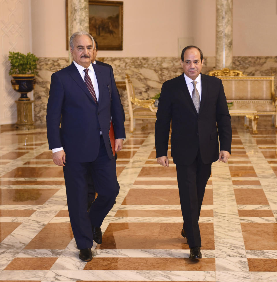 In this photo provided by Egypt's presidency media office, Egyptian President Abdel-Fattah el-Sissi, right, meets with the head of the self-styled Libyan National Army Field Marshal Khalifa Hifter in Cairo, Egypt, Sunday, April 14, 2019. Hifter launched a surprise offensive against Tripoli on April 5 and is battling rival militias loosely affiliated with a weak U.N.-backed government. (Egyptian Presidency Media office via AP)