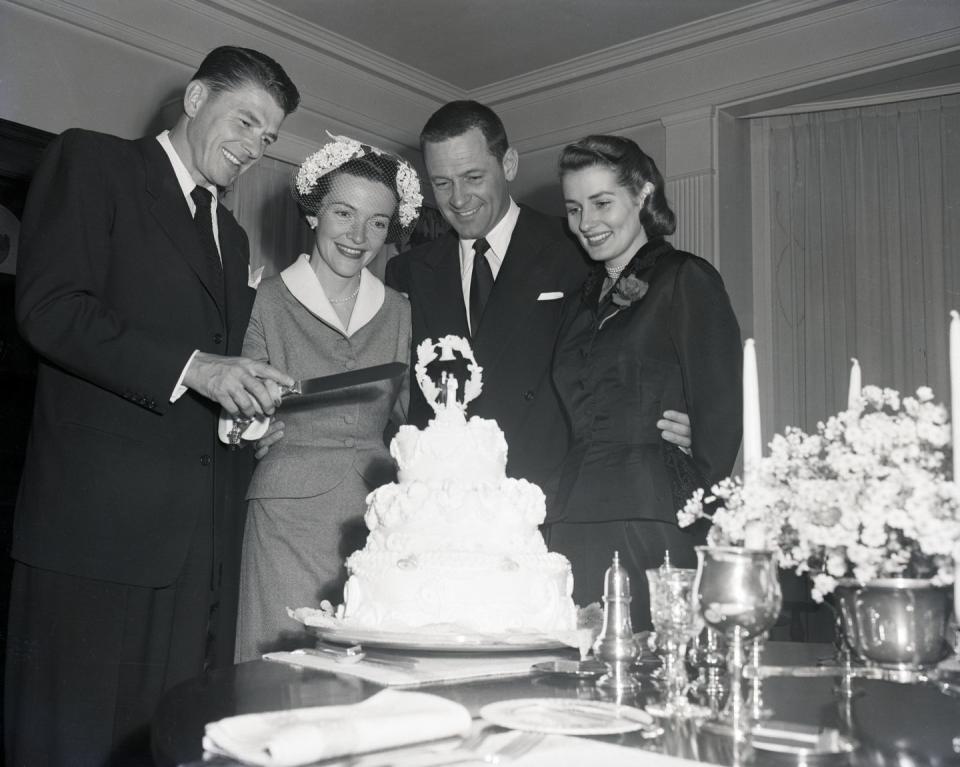 <p>They weren't in the White House just yet, so Hollywood actors Nancy Davis and Ronald Reagan tied the knot in a Hollywood home. Here, they cut the cake, while joined by their friends actor William Holden and his wife. </p>