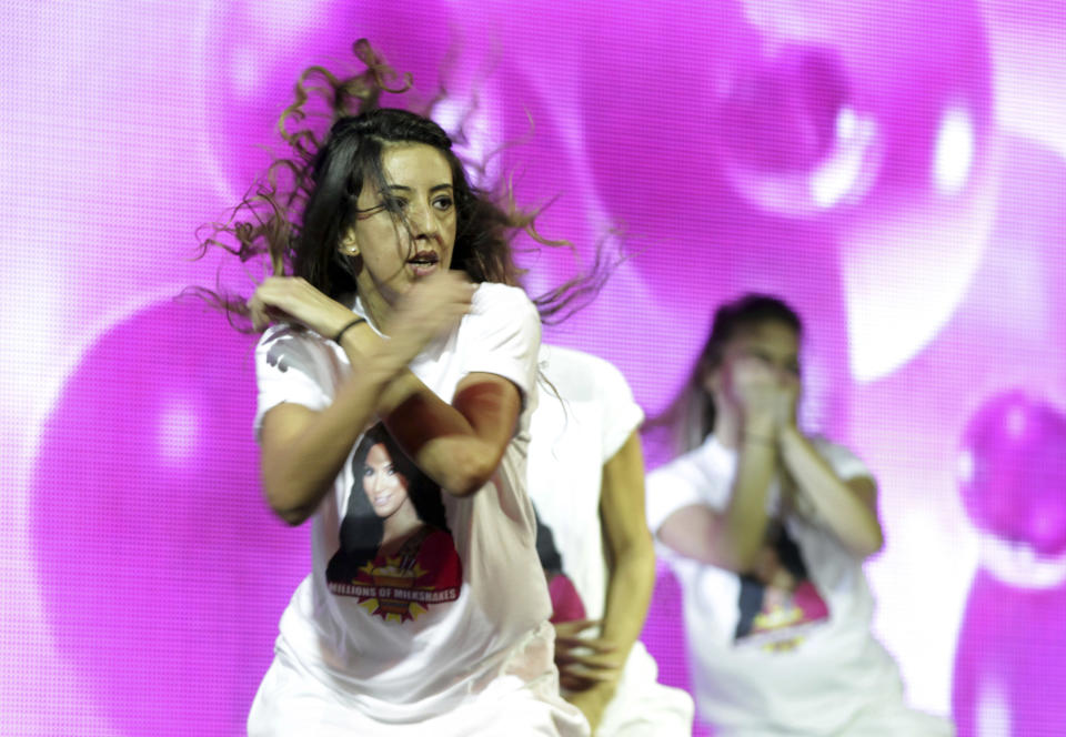 Dancers wearing t-shirts with a picture of TV star Kim Kardashian perform before her arrival in Riffa, Bahrain, Dec. 1, 2012. Just hours after reality TV star Kim Kardashian gushed about her impressions of Bahrain, riot police fired tear gas to disperse more than 50 hardline Islamic protesters denouncing her presence in the Gulf kingdom. (AP Photo/Hasan Jamali)