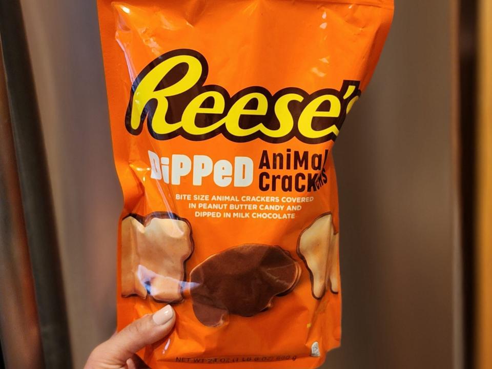 The writer holds a bag of Reese's dipped animal crackers
