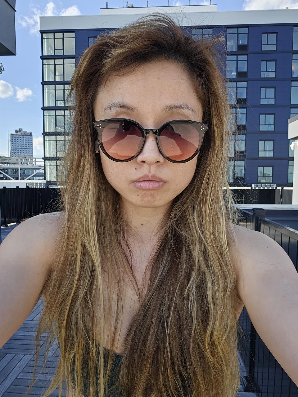 <p>Galaxy S23 Plus camera sample: A selfie of a woman with sunglasses on with no expression.</p>
