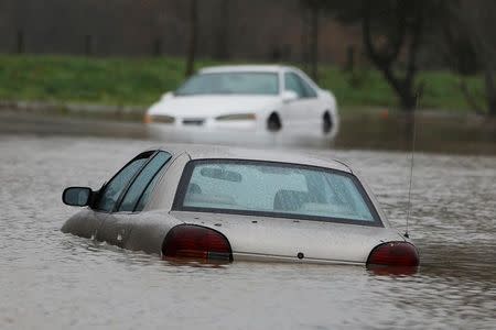 Vehicles submerged in flood waters are seen during a winter storm in Petaluma, California, January 8, 2017. REUTERS/Stephen Lam