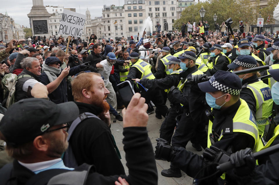 Image: Riot police face protesters who took part in a 'We Do Not Consent' rally at Trafalgar Square, organised by Stop New Normal, to protest against coronavirus restrictions, in London, (Frank Augstein / AP file)