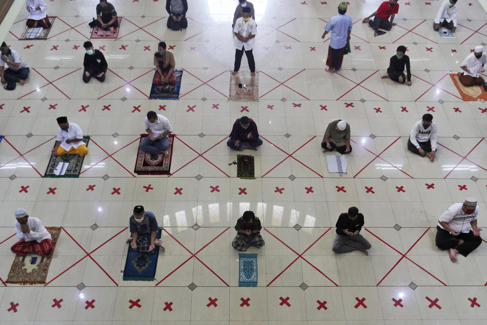 Muslims pray spaced apart to help curb the spread of the coronavirus during a Friday prayer at the Al Barkah Grand Mosque in Bekasi on the outskirts of Jakarta, Indonesia, Friday, May 29, 2020. Muslims in some parts of Indonesia attended Friday prayers as mosques closed by the coronavirus for weeks were allowed to start reopening in the world's most populous Muslim nation. (AP Photo/Achmad Ibrahim)