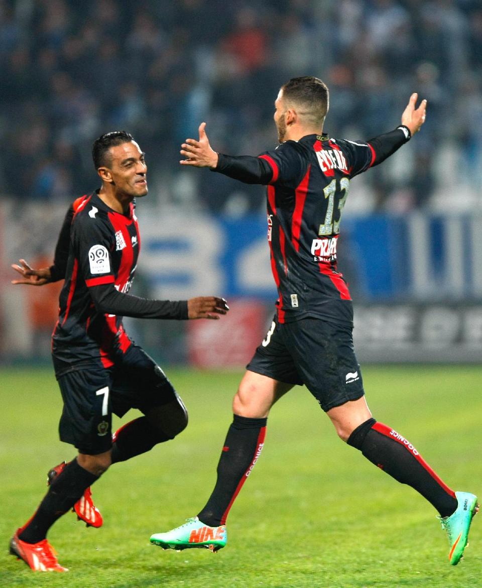 Nice's French midfielder Valentin Eysseric, right, reacts with Nice's French midfielder Fabrice Abriel, after scoring against Marseille, during their League One soccer match, at the Velodrome Stadium, in Marseille, southern France, Friday, March 7, 2014. (AP Photo/Claude Paris)