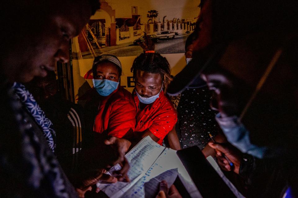 Haitian migrants line up in the early hours of the morning outside the Tijuana office of COMAR, Mexico's refugee agency in this file photo from 2021.