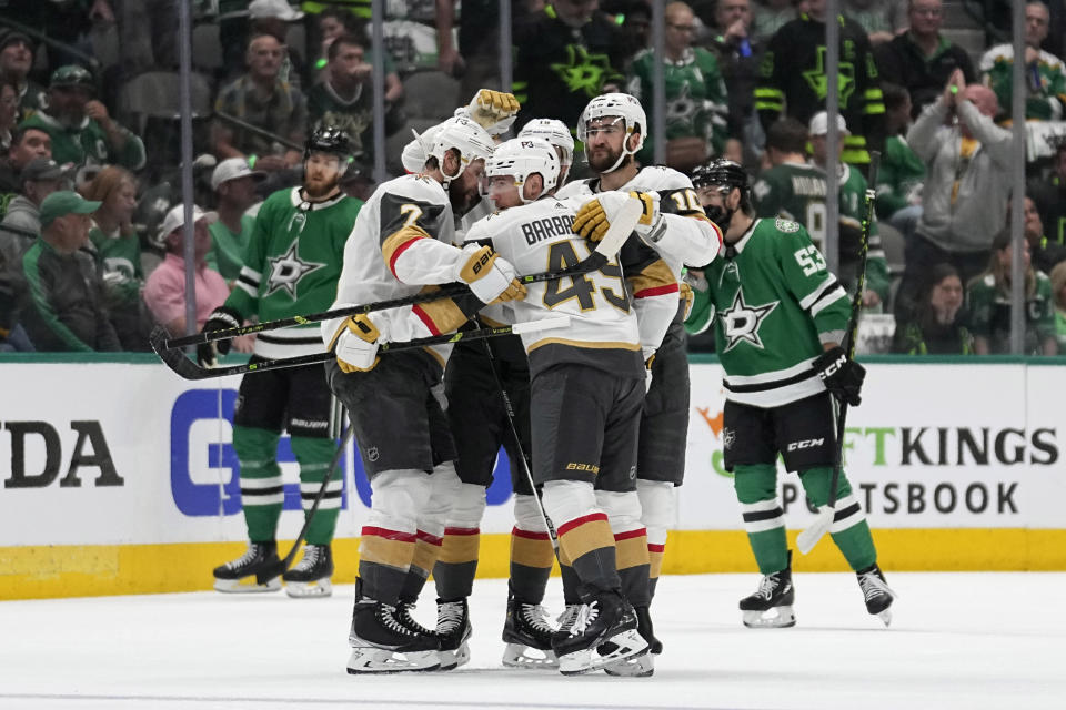 Vegas Golden Knights' Alex Pietrangelo (7), Ivan Barbashev (49), Nicolas Roy (10) and Reilly Smith, rear, celebrate a score by Barbashev against the Dallas Stars during the first period of Game 3 of the NHL hockey Stanley Cup Western Conference finals Tuesday, May 23, 2023, in Dallas. (AP Photo/Tony Gutierrez)