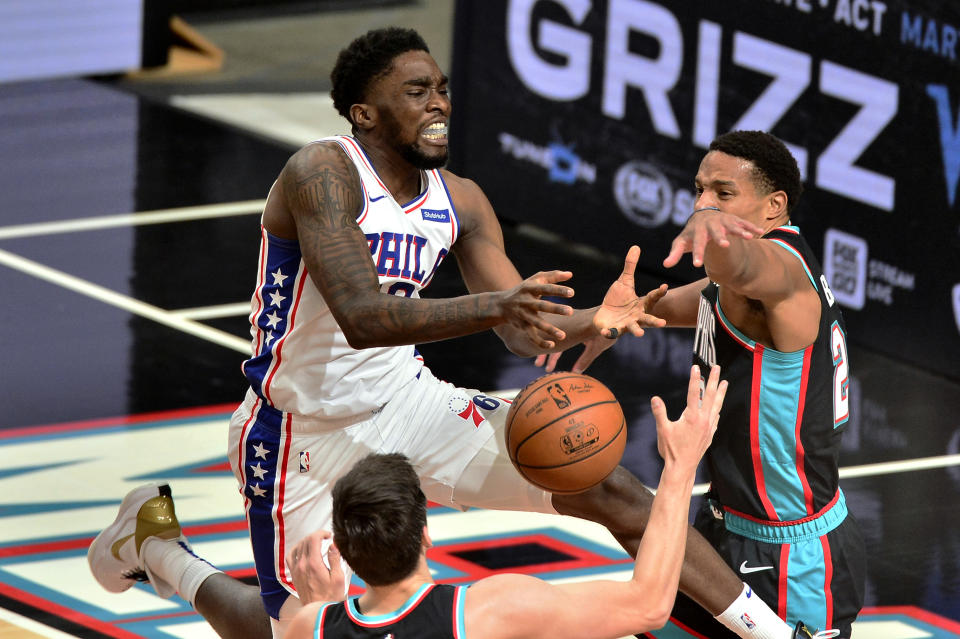 Philadelphia 76ers guard Shake Milton, left, loses control of the ball aas Memphis Grizzlies guard Desmond Bane, right, defends during the second half of an NBA basketball game Saturday, Jan. 16, 2021, in Memphis, Tenn. (AP Photo/Brandon Dill)