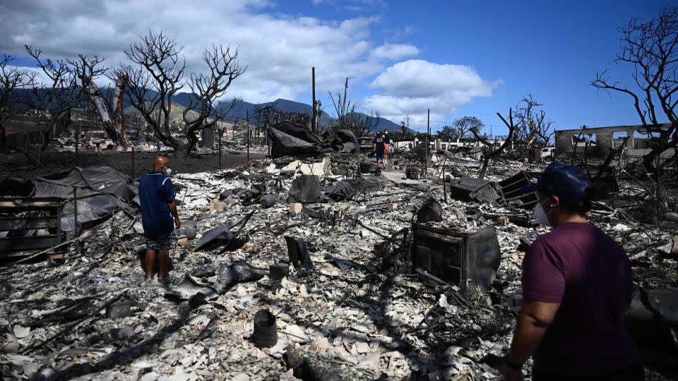 The Ganer family look through the ashes of their family's home on Malolo Place in the aftermath of a wildfire in Lahaina, western Maui, Hawaii on August 11, 2023. - Patrick T. Fallon/AFP/Getty Images