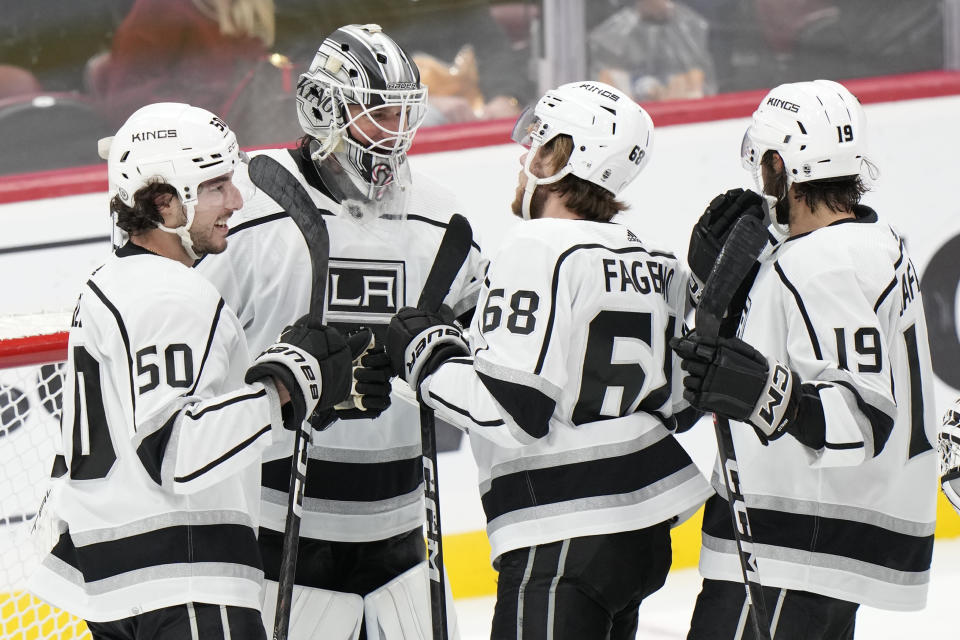 Los Angeles Kings goaltender Pheonix Copley, second from left, is congratulated by teammates after the Kings beat the Florida Panthers 4-3 during an NHL hockey game, Friday, Jan. 27, 2023, in Sunrise, Fla. From left: Sean Durzi, Copley, Samuel Fagemo and Alex Iafallo. (AP Photo/Wilfredo Lee)