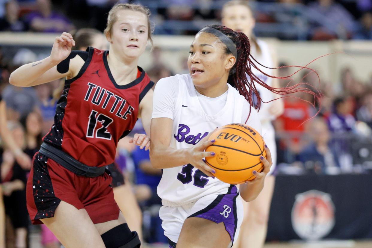 Bethany's Keziah Lofton moves past Tuttle's Ava Battles during a Class 4A girls high school basketball state tournament game between Bethany and Tuttle at State Fair Arena in Oklahoma City, Thursday, March 7, 2024.