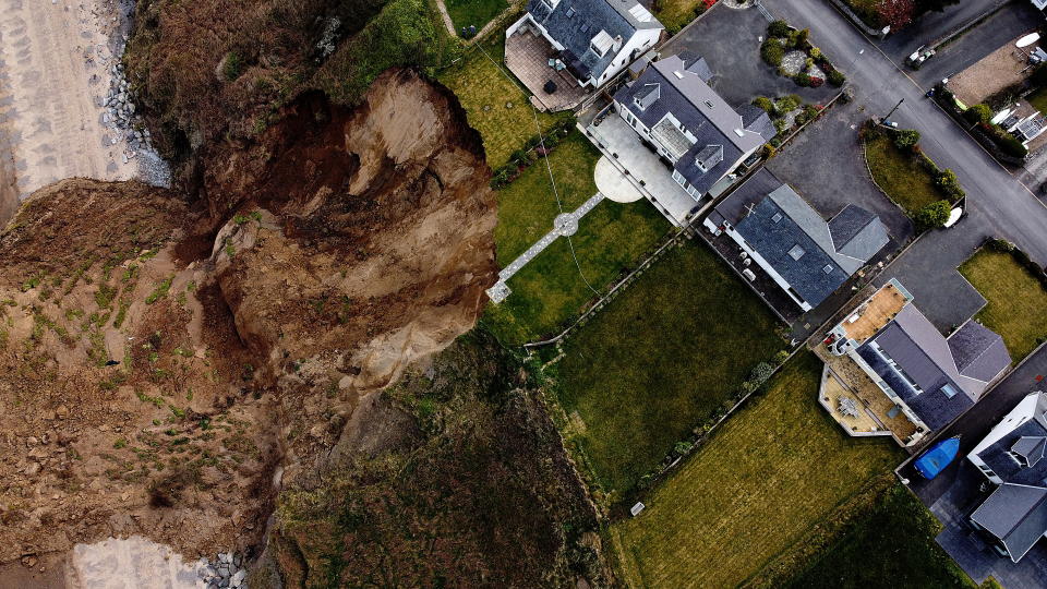 Houses are seen on the edge of a cliff after it collapsed in the village of Nefyn, Wales, Britain, April 20, 2021. Picture taken with a drone. REUTERS/Carl Recine