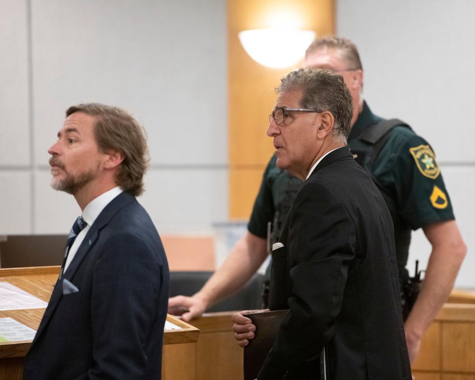 Pensacola dentist Charles Stamitoles waits in the courtroom with his legal team as they prepare for the jury selection process to begin Oct. 17.