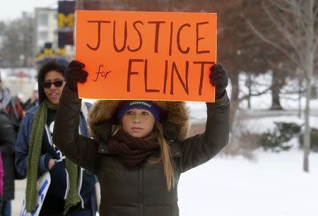 Demonstrators protest over the Flint, Michigan contaminated water crisis outside of the venue where the Democratic U.S. presidential candidates' debate was being held in Flint, Michigan in this March 6, 2016 file photo. REUTERS/Rebecca Cook Files