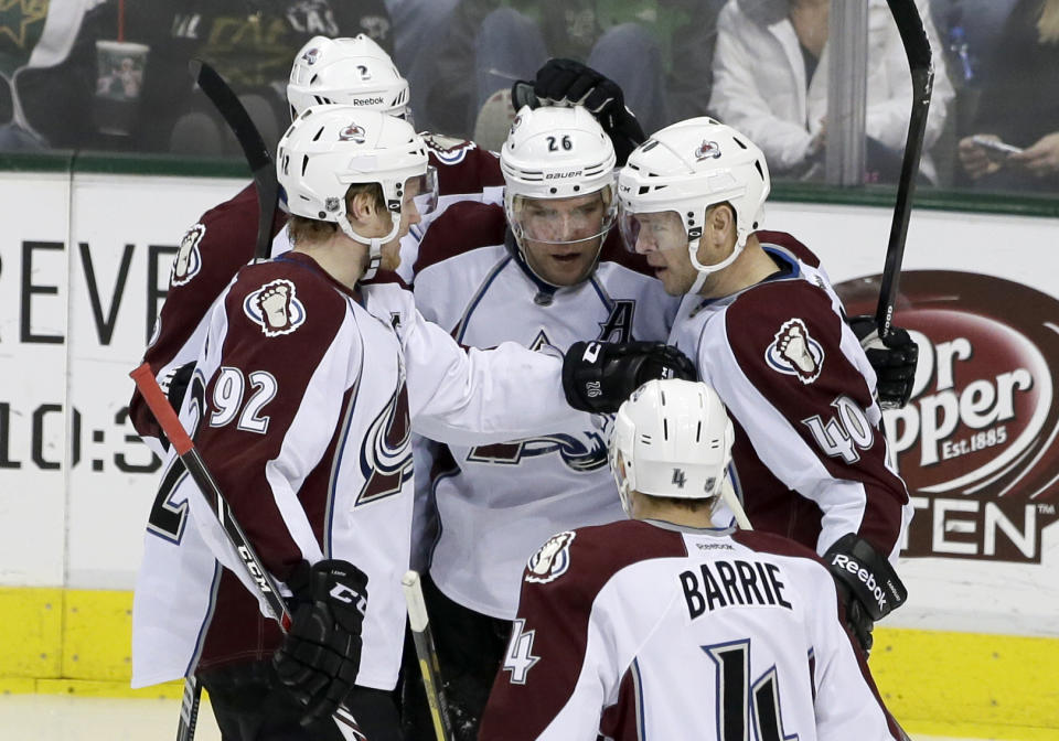 Colorado Avalanche's Gabriel Landeskog (92), of Sweden, Nick Holden (2), Tyson Barrie (4) and Paul Stastny (26) congratulate Alex Tanguay (40) on his goal in the third period of an NHL hockey game against the Dallas Stars, Monday, Jan. 27, 2014, in Dallas. Tanguay scored the game-winning goal early in the third period, and Semyon Varlamov made it stand up for the Colorado Avalanche in a 4-3 victory over the Stars on Monday. (AP Photo/Tony Gutierrez)