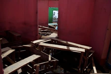 Schoolchairs scattered around in a school affected by Hurricane Matthew in Les Anglais, Haiti, October 10, 2016. REUTERS/Andres Martinez Casares