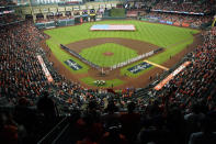 The Houston Astros and the Seattle Mariners line up for the national anthem before Game 1 of an American League Division Series baseball game in Houston,Tuesday, Oct. 11, 2022. (AP Photo/Eric Gay)