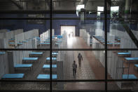 Beds are arranged in rows at a makeshift COVID-19 care center at an indoor sports stadium in New Delhi, India, Tuesday, June 30, 2020. Indian Prime Minister Narendra Modi said in a live address Tuesday that the country's coronavirus death rate is under control, but that the country is at a “critical juncture.” (AP Photo/Altaf Qadri)