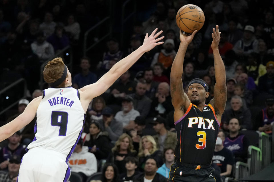 Phoenix Suns guard Bradley Beal (3) shoots a 3-pointer over Sacramento Kings guard Kevin Huerter (9) during the second half of an NBA basketball game Tuesday, Jan. 16, 2024, in Phoenix. The Suns won 119-117. (AP Photo/Ross D. Franklin)