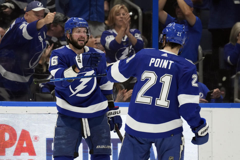 Tampa Bay Lightning right wing Nikita Kucherov (86) celebrates his goal against the New York Islanders with center Brayden Point (21) during the second period of an NHL hockey game Saturday, April 1, 2023, in Tampa, Fla. (AP Photo/Chris O'Meara)