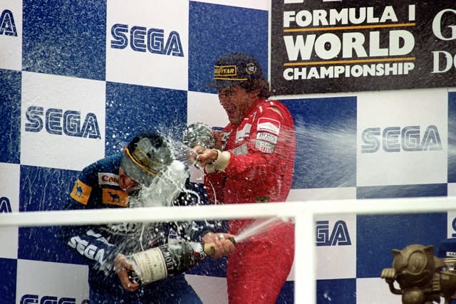 Ayrton Senna (right) sprays champagne over Damon Hill