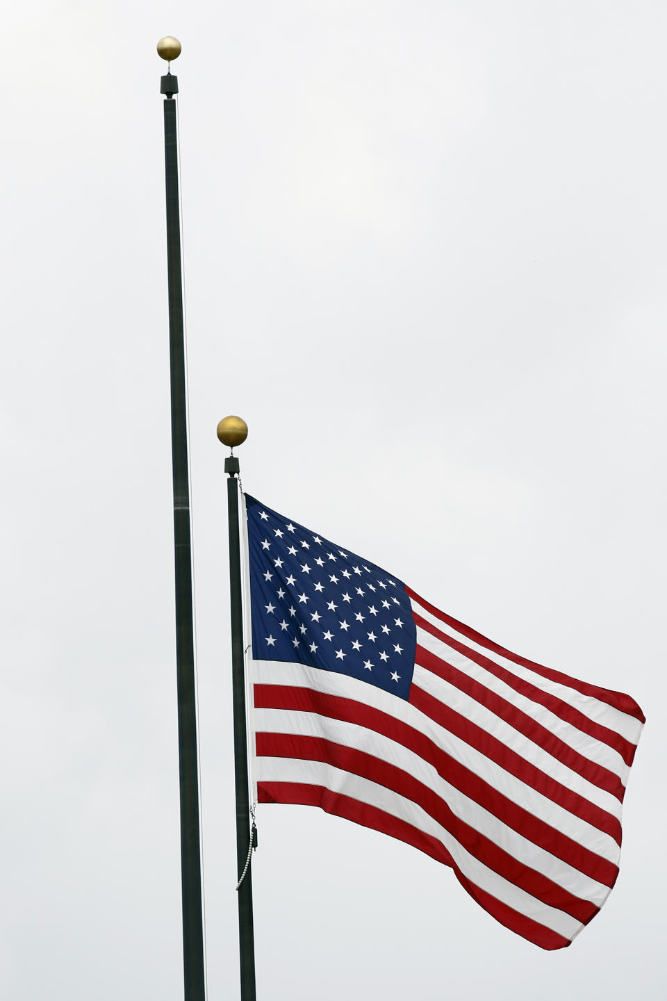 The Mississippi state flag was missing from its pole next to the American flag, outside the Carroll Gartin Justice Building in Jackson, Miss., Monday, June 29, 2020, the day after both chambers of the state Legislature passed a bill to take down and replace the current flag, which contains the Confederate battle emblem. (AP Photo/Rogelio V. Solis)