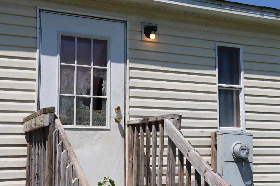 The broken window panes of the backdoor to Kesha Tate's home at Songbird Lane is shown on Thursday, Sept. 1, 2022 in Gaffney, S.C. The South Carolina family is seeking justice for Kesha Tate killed by her neighbor who was intoxicated and making target practice in his backyard. Nicholas Skylar Lucas is accused of murder in the shooting death of Tate after crime scene technicians debunked his claim that the shots ricocheted off his target.(AP Photo/James Pollard)