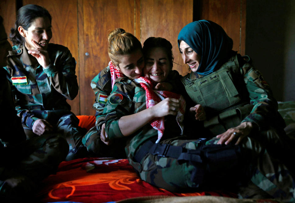 Fighters share a tender moment in a bedroom&nbsp;near their deployment.