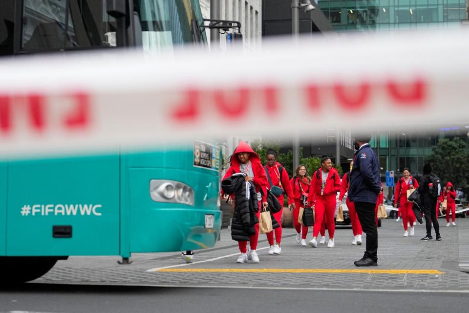 Members of the Philippines Women’s World Cup team walk to their team bus following a shooting near their hotel in the central business district in Auckland (Abbie Parr/AP) (AP)