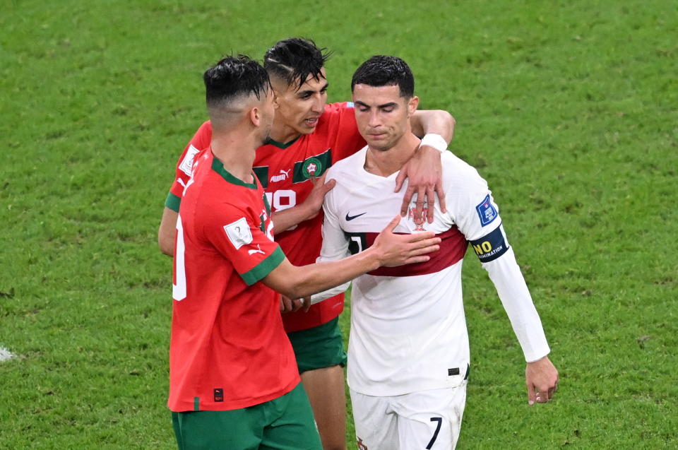 Moroccan players comfort disappointed C Lang following the game