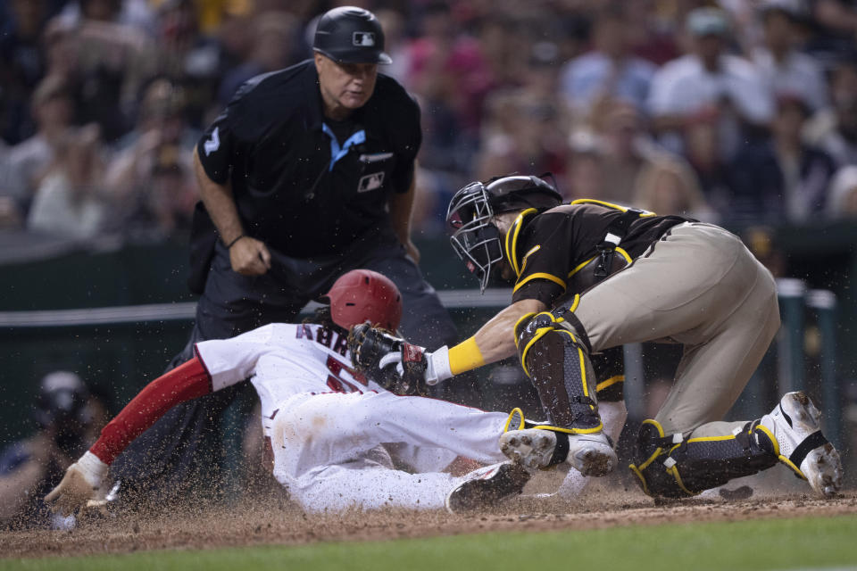San Diego Padres catcher Brett Sullivan tags out Washington Nationals' CJ Abrams (5) during the seventh inning of a baseball game in Washington, Wednesday, May 24, 2023. (AP Photo/Manuel Balce Ceneta)