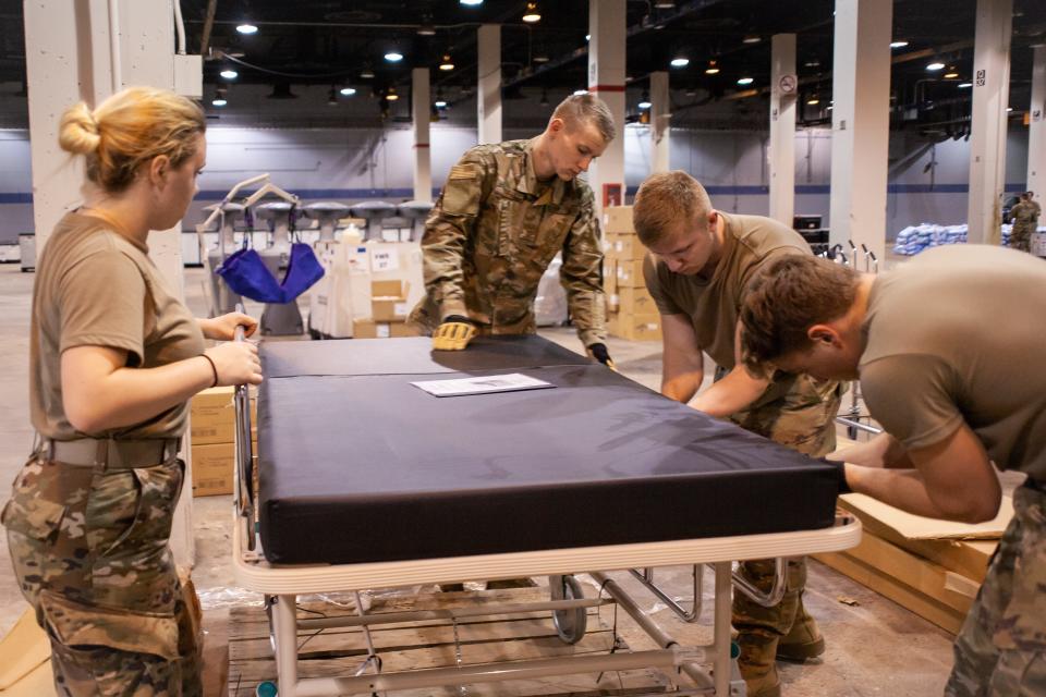 Members of the Illinois Air National Guard assemble medical equipment at the McCormick Place Convention Center in response to the COVID-19 pandemic in Chicago on March 30, 2020.