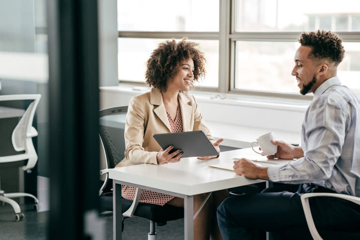 Financial advisors discuss a book of business to buy a financial firm.