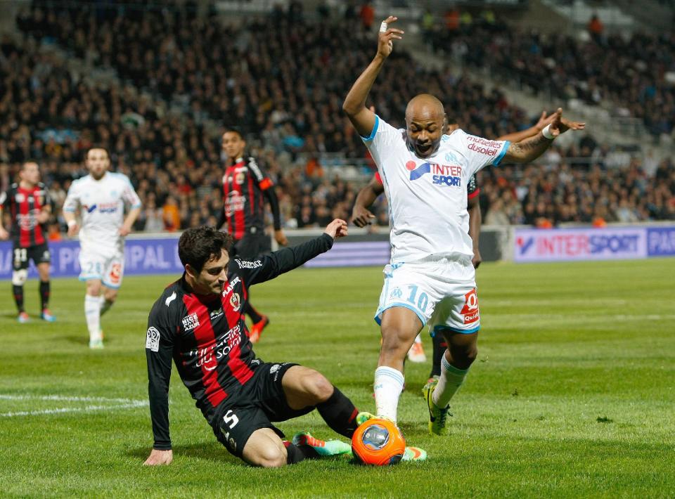 Marseille's Ghanaian forward Andre Ayew, right, challenges for the ball with Nice's French defender Gregoire Puel , during their League One soccer match, at the Velodrome Stadium, in Marseille, southern France, Friday, March 7, 2014. (AP Photo/Claude Paris)