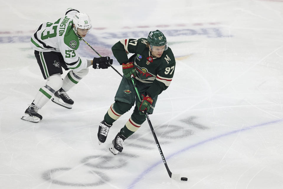 Minnesota Wild left wing Kirill Kaprizov (97) handles the puck against Dallas Stars center Wyatt Johnston (53) during the first period of Game 4 of an NHL hockey Stanley Cup first-round playoff series Sunday, April 23, 2023, in St. Paul, Minn. (AP Photo/Stacy Bengs)