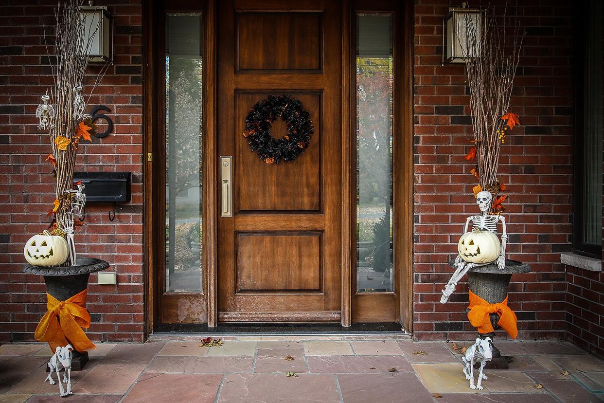 A suburban residential home is decorated in orange and black for the Halloween holiday.
