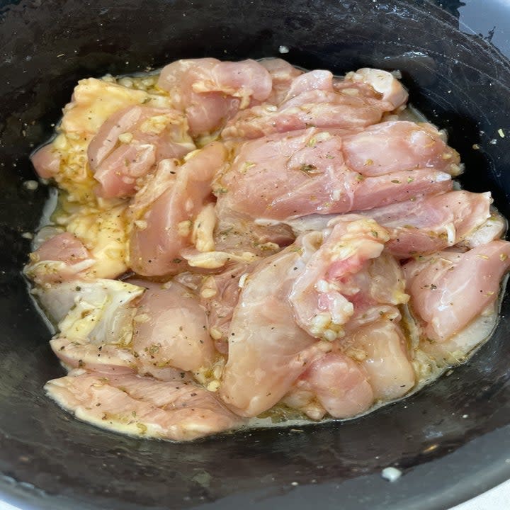 chicken marinading in a bowl