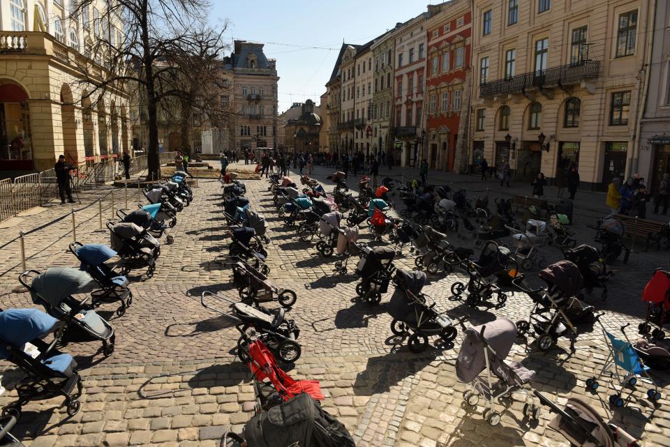 109 empty strollers are seen placed outside the Lviv city council building, highlighting the number of children killed in the ongoing Russia's invasion of Ukraine according to Ukrainian officials,   March 18, 2022. / Credit: YURIY DYACHYSHYN/AFP/Getty