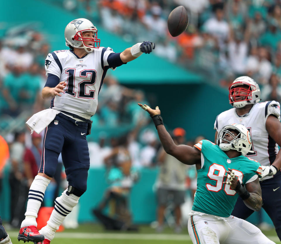 <p>Patriots quarterback Tom Brady lunges for the ball as the Dolphins Charles Harris reaches for it as well. Brady’s pass attempt was deflected, and the ball came back in his direction, but it fell to the ground for an incompletion. The New England Patriots visited the Miami Dolphins in a regular season NFL football game at Hard Rock Stadium. (Jim Davis/Globe Staff) </p>