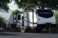 People look at an RV for sale at a dealership in Dover