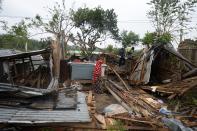 Villagers repair their house damaged by cyclone Amphan in Satkhira on May 21, 2020. (Photo by MUNIR UZ ZAMAN/AFP via Getty Images)