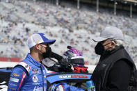 NASCAR Cup Series driver Kyle Larson, left, talks to the owner of the NASCAR team Hendrick Motorsports, Rick Hendrick, right, before a NASCAR Cup Series at Atlanta Motor Speedway on Sunday, March 21, 2021, in Hampton, Ga. (AP Photo/Brynn Anderson)