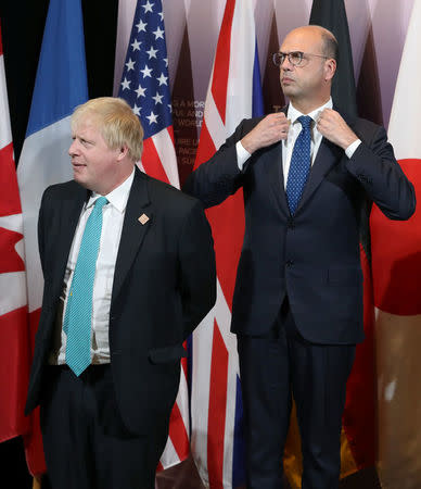 Britain's Foreign Secretary Boris Johnson and Italy's Minister of Foreign Affairs Angelino Alfano wait for a group photo to take place on the second day of meetings for foreign ministers from G7 countries in Toronto, Ontario, Canada April 23, 2018. REUTERS/Fred Thornhill