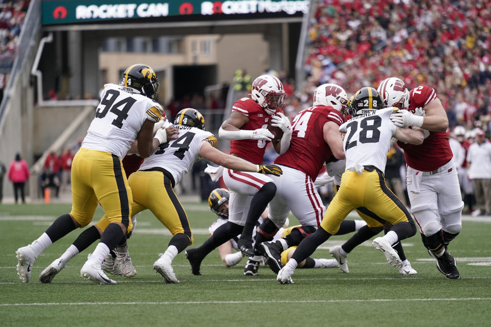 Wisconsin running back Chez Mellusi (6) runs against Iowa linebacker Seth Benson (44) during the first half of an NCAA college football game Saturday, Oct. 30, 2021, in Madison, Wis. (AP Photo/Andy Manis)