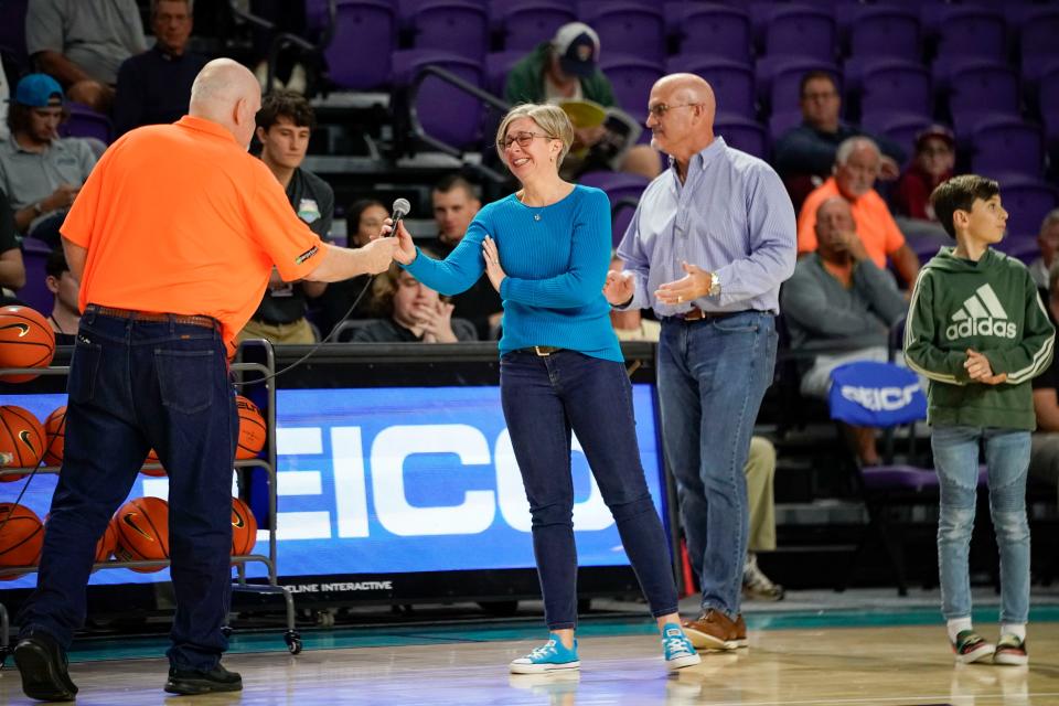 The family of John Naylor is handed the microphone during a remembrance of him during the 49th annual City of Palms Classic at Suncoast Arena in Ft. Myers on Friday, Dec. 16, 2022. 