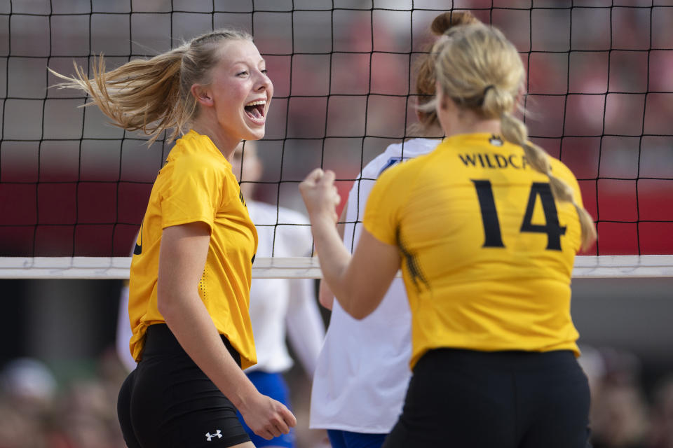 Wayne State's Laney Kathol, left, celebrates with her Rachel Walker after scoring a kill against Nebraska-Kearney during the second set of a college volleyball match at Memorial Stadium on Wednesday, Aug. 30, 2023, in Lincoln, Neb. (Kenneth Ferriera/Lincoln Journal Star via AP)