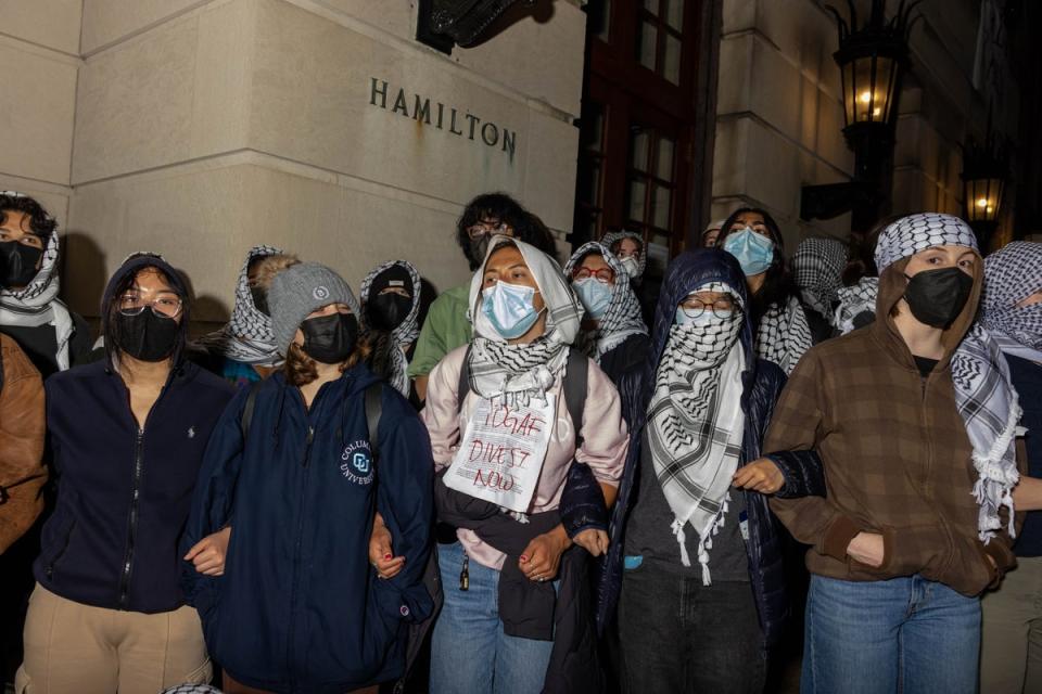 Student demonstrators lock arms to guard against authorities reaching fellow protesters who barricaded themselves inside Hamilton Hall (Getty Images)
