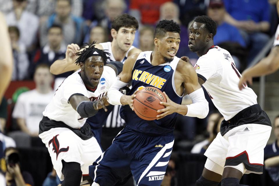 March 20, 2015; Seattle, WA, USA; UC Irvine Anteaters forward Will Davis II (3) controls the ball against Louisville Cardinals forward Montrezl Harrell (24) and forward/center Mangok Mathiang (12) during the second half of the second round of the 2015 NCAA Tournament at KeyArena. 