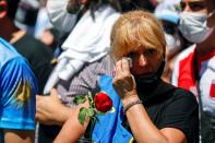 People wait outside the Casa Rosada presidential palace ahead of the wake of late soccer legend Diego Armando Maradona, in Buenos Aires