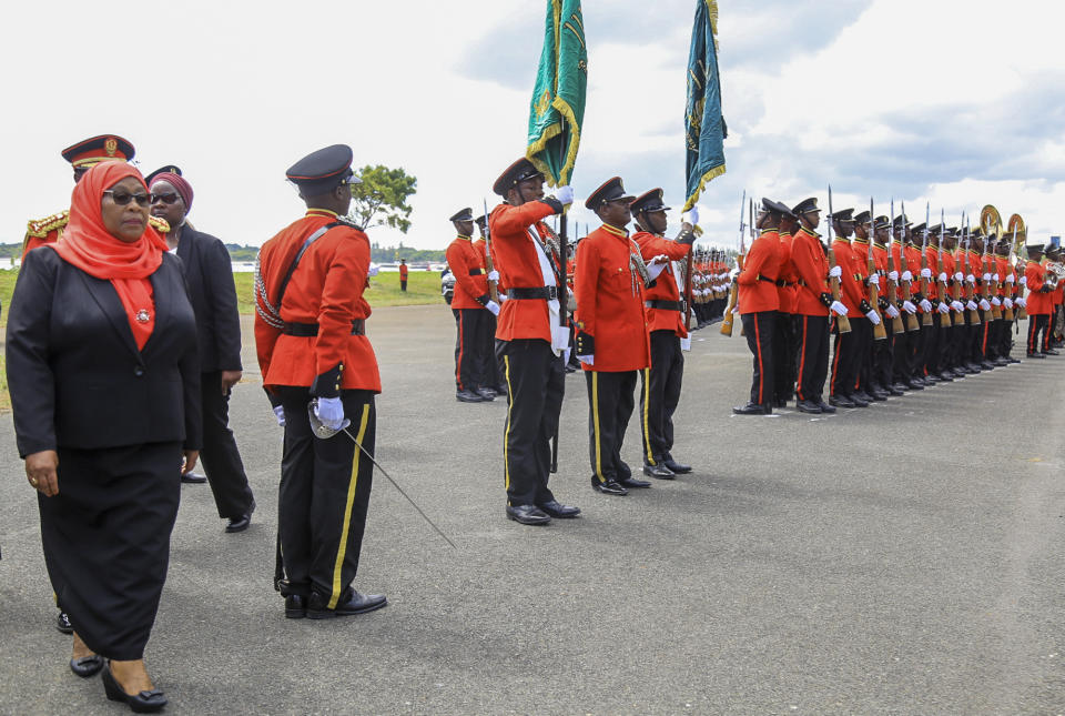 Tanzania's new president Samia Suluhu Hassan, left, inspects the guard of honor after being sworn in at a ceremony at State House in Dar es Salaam, Tanzania Friday, March 19, 2021. Samia Suluhu Hassan made history Friday when she was sworn in as Tanzania's first female president, following the death of her predecessor John Magufuli. (AP Photo)